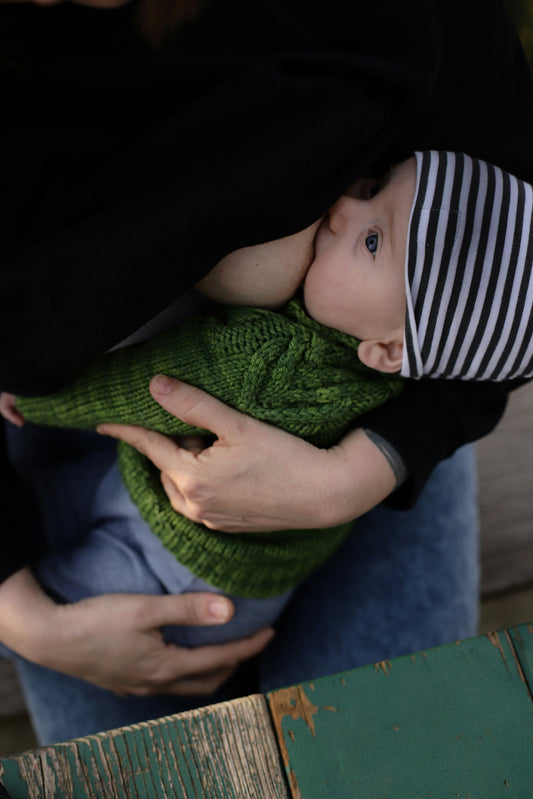 Nursing mom with baby with striped hat