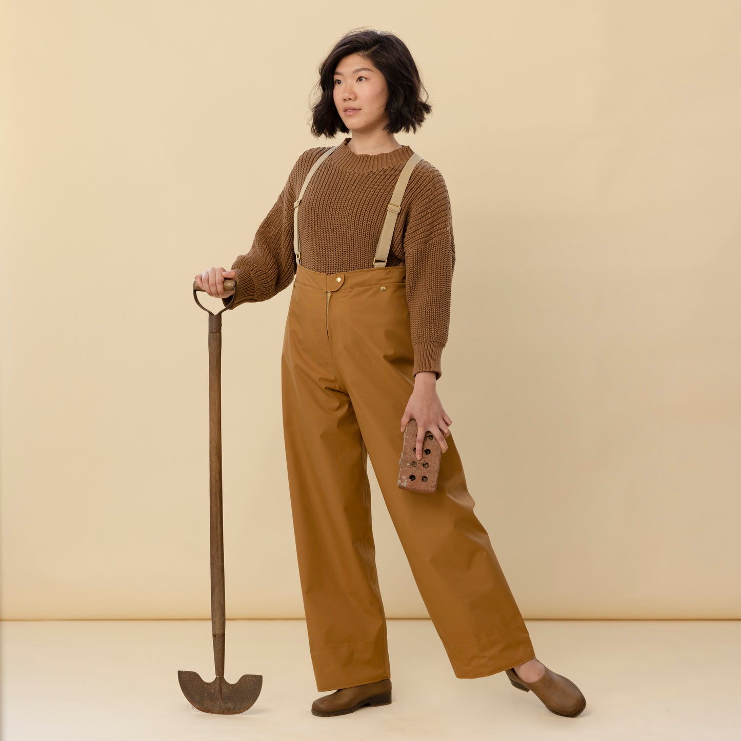 Front view of fairechild Women’s Rain Pants in Bark with adjustable suspenders and wide leg