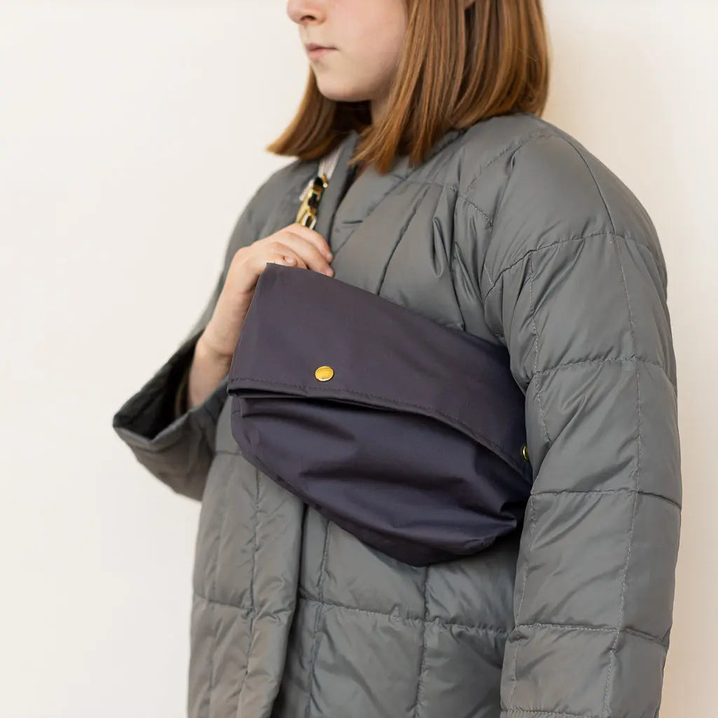 Carry all the essentials for your adventure in the Fanny Pack. It’s 100% waterproof and has a single front pocket with brass snaps that’s designed for keeping valuables safe and dry. The adjustable hip strap features lovely brass details and it’s designed to fit any size.