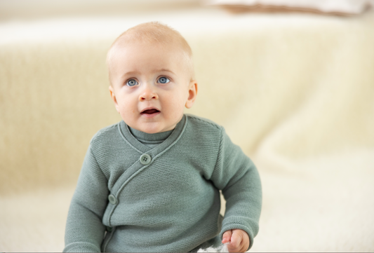Baby wearing Disana Merino Wool Cardigan – Cozy Organic Knitwear for Newborns and Toddlers